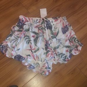 White multi colored flowers shorts with elastic waist and draw string tie